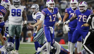 Buffalo Bills quarterback Josh Allen (17) celebrates after recovering a fumbled snap and getting a first down on the play in the first half of an NFL football game against the Dallas Cowboys in Arlington, Texas, Thursday, Nov. 28, 2019. The Cowboys&#39; Maliek Collins (96) and Bills Jon Feliciano (76) look on during the play. (AP Photo/Michael Ainsworth)