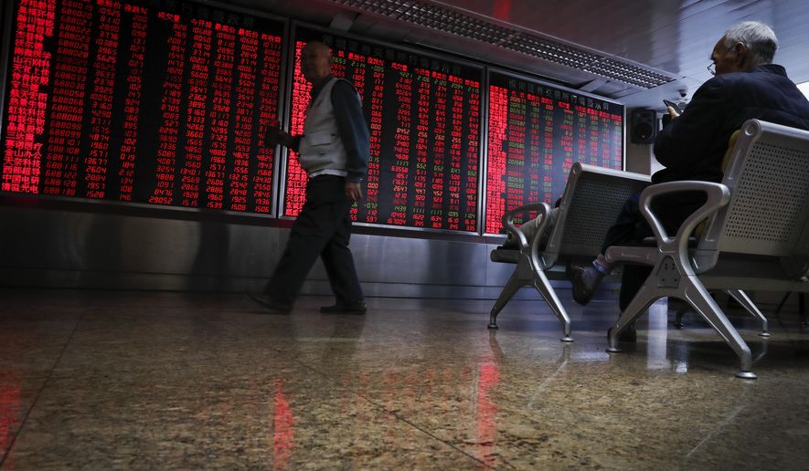 Chinese investors monitor stock prices at a brokerage house in Beijing, Thursday, Nov. 28, 2019. Asian shares were mostly lower on Thursday after President Donald Trump signed a bill expressing support for human rights in Hong Kong. (AP Photo/Andy Wong)