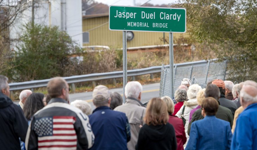 A large crowd gathers on Ash Street for the unveiling of the sign for the Jasper Duel Clardy Memorial Bridge in Bristol, Tenn., on Wednesday, Nov. 20, 2019. (David Crigger/Bristol Herald Courier via AP)