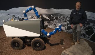 Kjetil Wormnes, automation and robotics system engineer, poses with the Space Rover after a training exercise of the European Space Agency, ESA, in Katwijk, near The Hague, Netherlands, Monday, Nov. 25, 2019. (AP Photo/Peter Dejong)