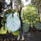 In this photo taken Monday, Nov. 25, 2019, Lisa Wathne holds original sea turtle costumes, like the one she wore 20 years earlier that were made for protesters at the World Trade Organization (WTO) demonstrations in Seattle, in Lake Forest Park, Wash. Wathne and other demonstrators wore the cardboard turtle shells to protest WTO policies, including one interpreted by protesters as disregarding the plight of turtles killed by shrimp nets. A wide array of issues brought tens of thousands of protesters to Seattle 20 years ago Saturday, with one unifying theme: concern that the World Trade Organization, a then-little-known body charged with regulating international trade, threatened them all. (AP Photo/Elaine Thompson)