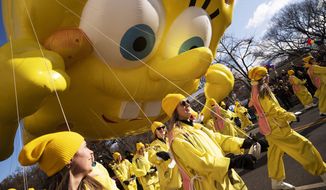 Balloon handlers hold SpongeBob Square Pants balloon close to the ground as strong winds affect the Macy&#39;s Thanksgiving Day Parade, Thursday, Nov. 28, 2019, in New York. (AP Photo/Mark Lennihan)