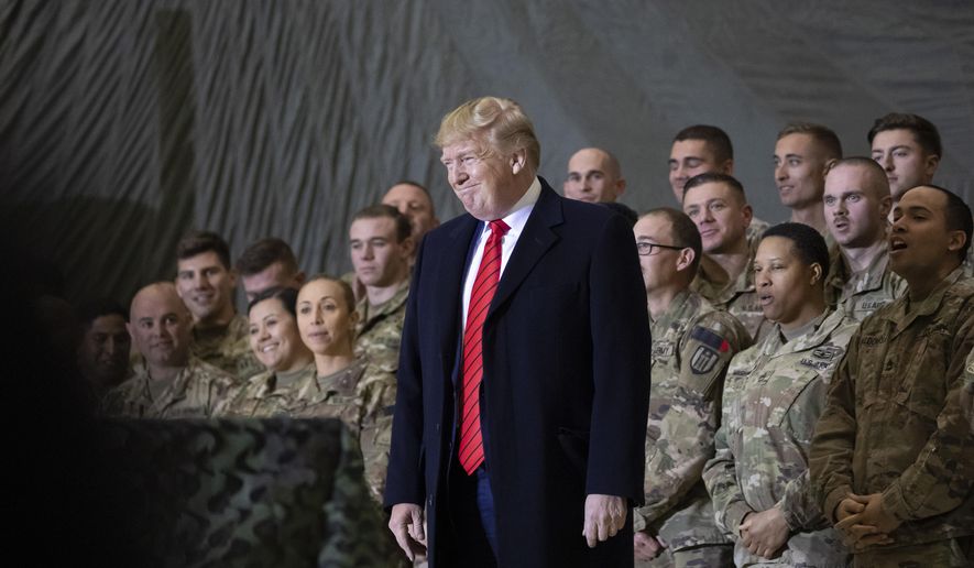President Donald Trump smiles before addressing members of the military during a surprise Thanksgiving Day visit, Thursday, Nov. 28, 2019, at Bagram Air Field, Afghanistan. (AP Photo/Alex Brandon)