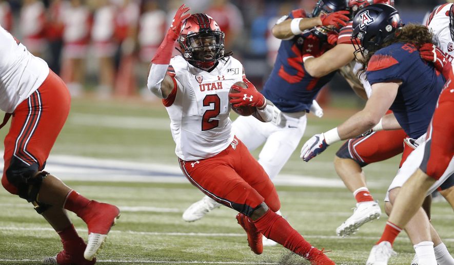 Utah running back Zack Moss (2) runs for a first down against Arizona during the first half of an NCAA college football game Saturday, Nov. 23, 2019, in Tucson, Ariz. (AP Photo/Rick Scuteri)