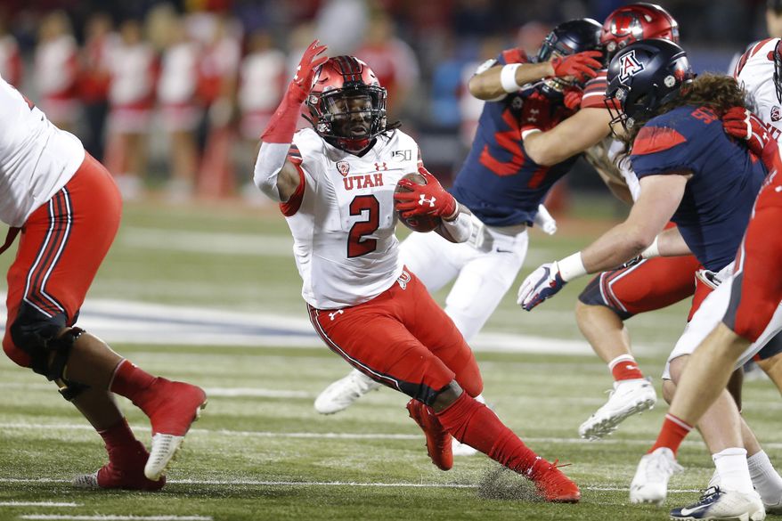 Utah running back Zack Moss (2) runs for a first down against Arizona during the first half of an NCAA college football game Saturday, Nov. 23, 2019, in Tucson, Ariz. (AP Photo/Rick Scuteri)