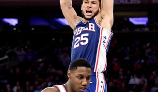 Philadelphia 76ers guard Ben Simmons (25) dunks over New York Knicks forward RJ Barrett (9) during the second half of an NBA basketball game Friday, Nov. 29, 2019, in New York. (AP Photo/Steven Ryan)