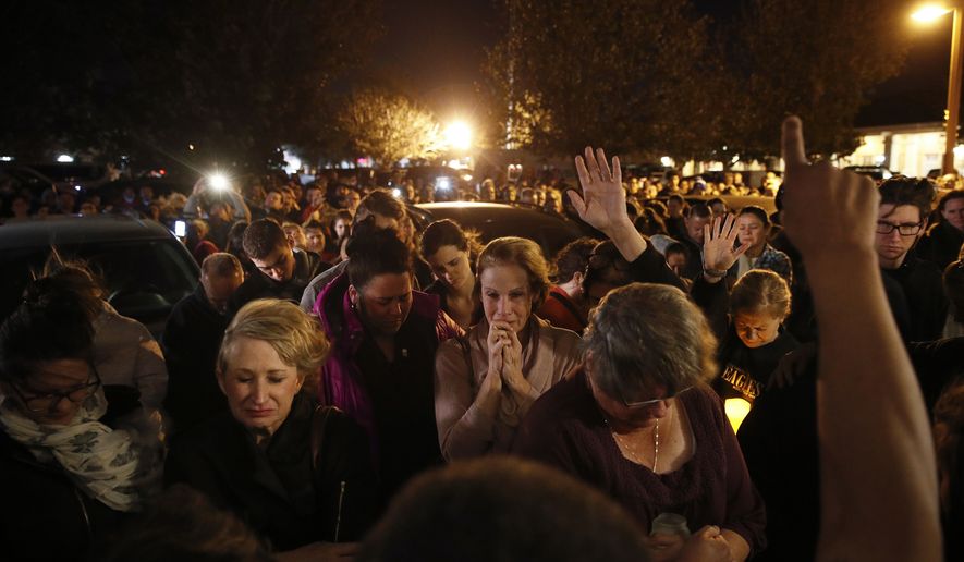 In this Nov. 8, 2018, file photo, people gather outside the Rivalry Roasters coffee shop for a vigil for Sean Adler in Simi Valley, Calif. Adler was killed in a shooting at the Borderline Bar & Grill in Thousand Oaks, Calif., on Nov. 7, 2018. The Southern California country-western bar where 12 people were killed in the shooting and gunbattle will reopen more than a year after the tragedy, the bar's owners say in a video posted Thursday, Nov. 28, 2019. (AP Photo/Jae C. Hong, File) **FILE**