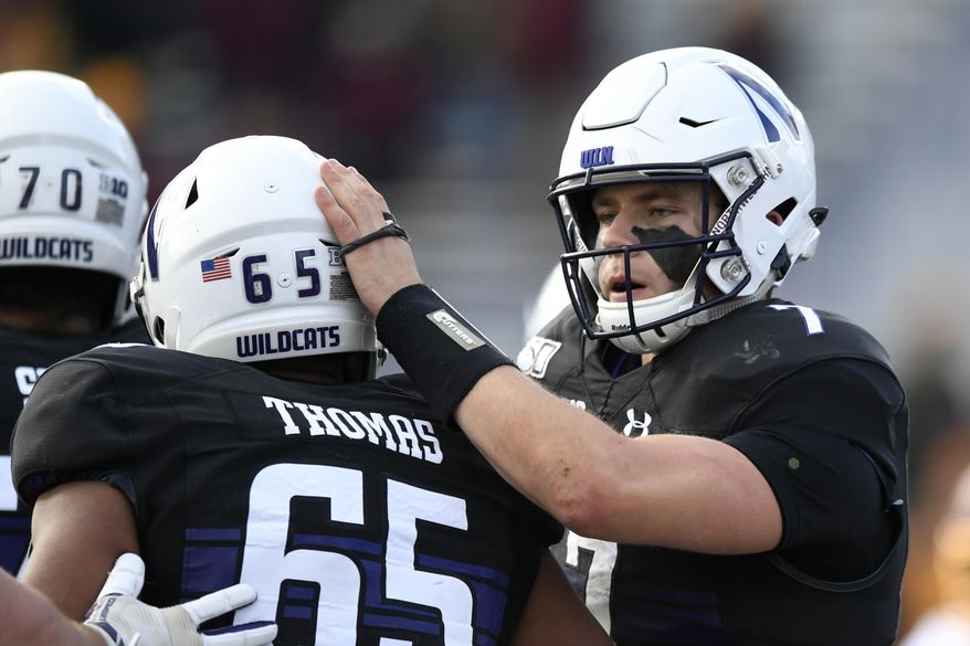 Northwestern quarterback Andrew Marty (7) celebrates with teammate Jared Thomas (65) after rushing for a touchdown during the second half of an NCAA football game against Minnesota Saturday, Nov. 23, 2019, in Evanston, Ill. Minnesota won 38-22. (AP Photo/Paul Beaty)