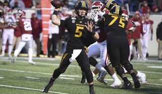 Missouri quarterback Taylor Powell drops back to pass against Arkansas during the second half of an NCAA college football game Friday, Nov. 29, 2019, in Little Rock, Ark. (AP Photo/Michael Woods)