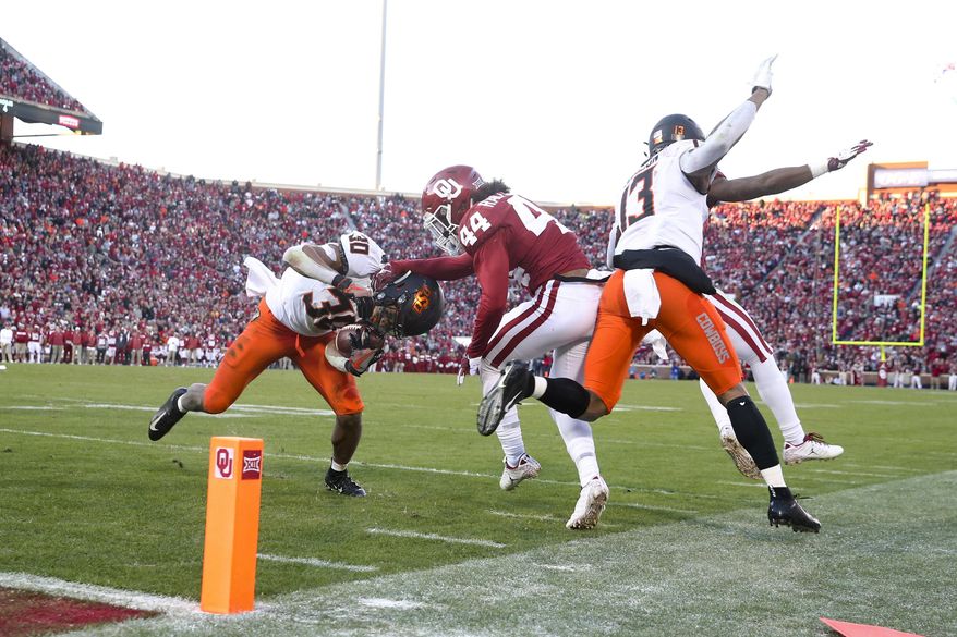 FILE - In this Nov. 10, 2018, file photo, Oklahoma defensive back Brendan Radley-Hiles (44) tackles Oklahoma State running back Chuba Hubbard (30) during an NCAA college football game in Norman, Okla. For the four-time defending Big 12 champion Sooners, still trying to get back to the College Football Playoff for the fourth time in five seasons, Bedlam is another long standing rivalry against a Big 12 foe. (Ian Maule/Tulsa World via AP, File)