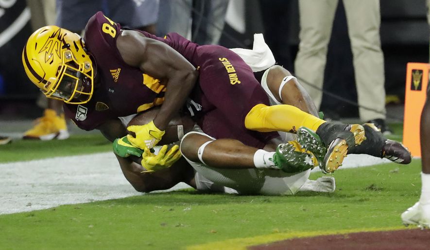 Arizona State wide receiver Frank Darby, top, pulls in a touchdown catch as Oregon cornerback Deommodore Lenoir defends during the second half of an NCAA college football game, Saturday, Nov. 23, 2019, in Tempe, Ariz. Arizona State won 31-28. (AP Photo/Matt York)