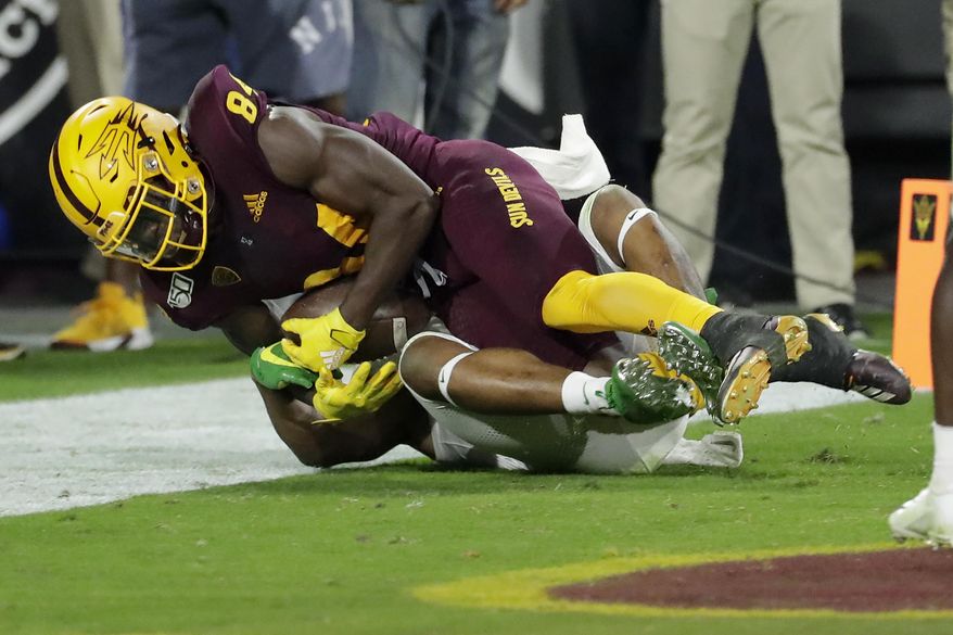 Arizona State wide receiver Frank Darby, top, pulls in a touchdown catch as Oregon cornerback Deommodore Lenoir defends during the second half of an NCAA college football game, Saturday, Nov. 23, 2019, in Tempe, Ariz. Arizona State won 31-28. (AP Photo/Matt York)