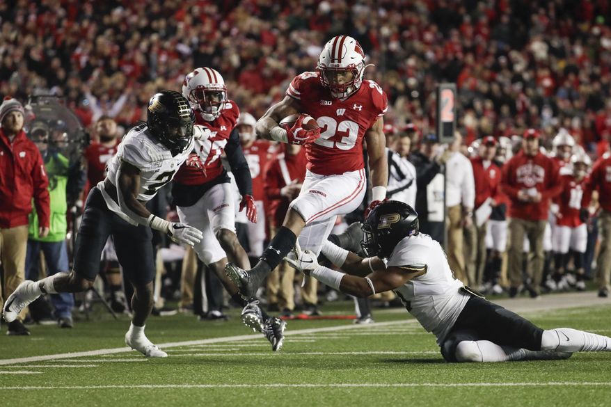 Wisconsin's Jonathan Taylor runs during the second half of an NCAA college football game against Purdue Saturday, Nov. 23, 2019, in Madison, Wis. (AP Photo/Morry Gash)