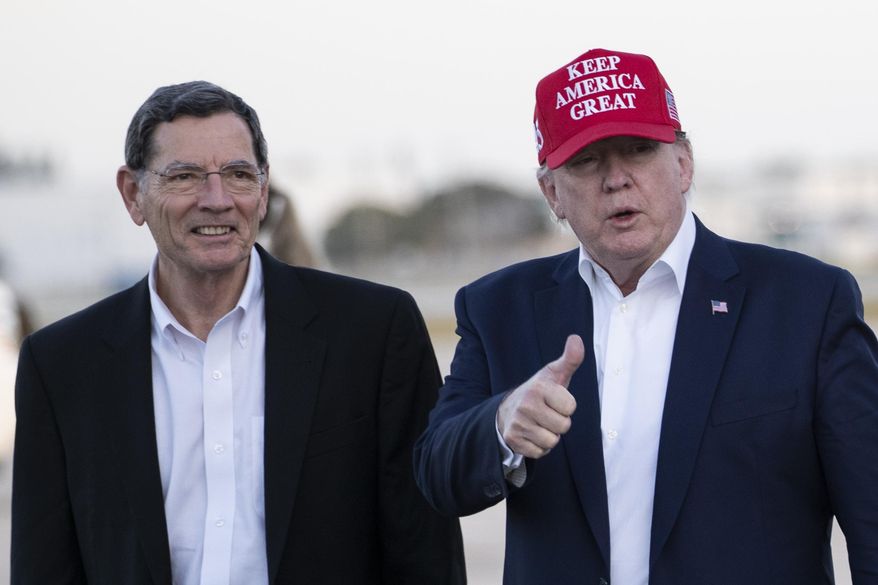 President Donald Trump gives thumbs up as he steps off Air Force One, accompanied by Sen. John Barrasso, R-Wyo., at the Palm Beach International Airport, Friday, Nov. 29, 2019, in West Palm Beach, Fla. (AP Photo/Alex Brandon)
