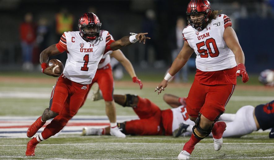 Utah quarterback Tyler Huntley (1) directs traffic during the the second half of the team's NCAA college football game against Arizona, Saturday, Nov. 23, 2019, in Tucson, Ariz. (AP Photo/Rick Scuteri)