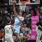 Miami Heat forward Meyers Leonard (0) shoots over Golden State Warriors center Willie Cauley-Stein (2) and forward Draymond Green, right, during the first half of an NBA basketball game, Friday, Nov. 29, 2019, in Miami. (AP Photo/Lynne Sladky)