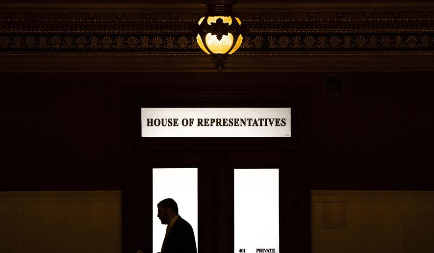FILE - In this Nov. 20, 2019 file photo, Rep. Mark Rozzi, D-Berks, is silhouetted as he passes a window in the Pennsylvania Capitol in Harrisburg, Pa. When Pennsylvania overhauled its child sexual abuse laws this week, absent from the bill-signing ceremony were some survivors and victim advocates who feel conflicted by the compromise package. Rozzi predicted that a referendum will pass easily because voters who have read about sexual abuse scandals understand the need to deliver justice to victims. (AP Photo/Matt Rourke, File)
