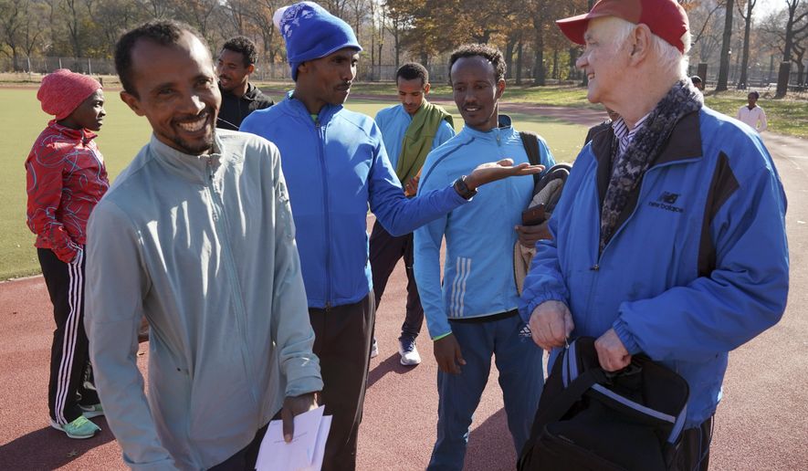 Bill Staab, right, talks with a group of Ethiopian runners after a short workout at Van Cortlandt Park in the Bronx borough of New York, Tuesday, Nov. 26, 2019. Girma Bekele Gebre stunned the elite field at the New York City Marathon by finishing third as a nonelite entrant in November. It was a life-changing performance for the Ethiopian runner, and one made possible because of his involvement with the West Side Runners' Club. Staab, the team president, has spent four decades helping immigrant runners acquire visas and gain entry to U.S. races, spending nearly $1 million of his own money to cover fees. Bekele Gebre is his greatest success, but not nearly the only runner he's helped. (AP Photo/Seth Wenig)