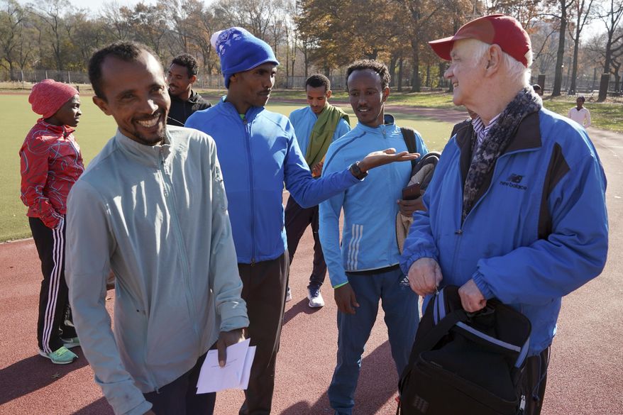Bill Staab, right, talks with a group of Ethiopian runners after a short workout at Van Cortlandt Park in the Bronx borough of New York, Tuesday, Nov. 26, 2019. Girma Bekele Gebre stunned the elite field at the New York City Marathon by finishing third as a nonelite entrant in November. It was a life-changing performance for the Ethiopian runner, and one made possible because of his involvement with the West Side Runners' Club. Staab, the team president, has spent four decades helping immigrant runners acquire visas and gain entry to U.S. races, spending nearly $1 million of his own money to cover fees. Bekele Gebre is his greatest success, but not nearly the only runner he's helped. (AP Photo/Seth Wenig)