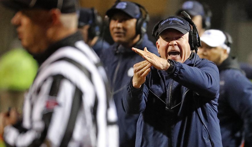 North Carolina head coach Mack Brown runs to take a timeout during the first half of an NCAA college football game against North Carolina State in Raleigh, N.C., Saturday, Nov. 30, 2019. (AP Photo/Karl B DeBlaker)