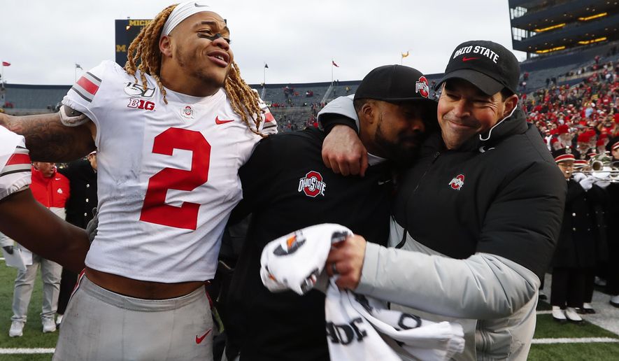 Ohio State defensive end Chase Young (2), linebackers coach Al Washington and head coach Ryan Day celebrate after a 56-27 win against Michigan after an NCAA college football game in Ann Arbor, Mich., Saturday, Nov. 30, 2019. (AP Photo/Paul Sancya)