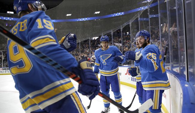 St. Louis Blues&#x27; Nathan Walker (26) is congratulated by teammates Jay Bouwmeester (19) and Brayden Schenn, center, after scoring during the second period of an NHL hockey game against the Pittsburgh Penguins, Saturday, Nov. 30, 2019, in St. Louis. (AP Photo/Jeff Roberson)