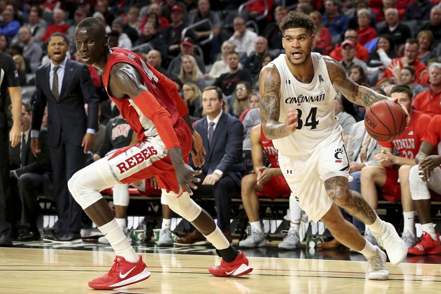 Cincinnati guard Jarron Cumberland (34) drives to the basket as UNLV forward Cheikh Mbacke Diong (34) defends during the first half of an NCAA college basketball game Saturday, Nov. 30, 2019, in Cincinnati. (Kareem Elgazzar/The Cincinnati Enquirer via AP)