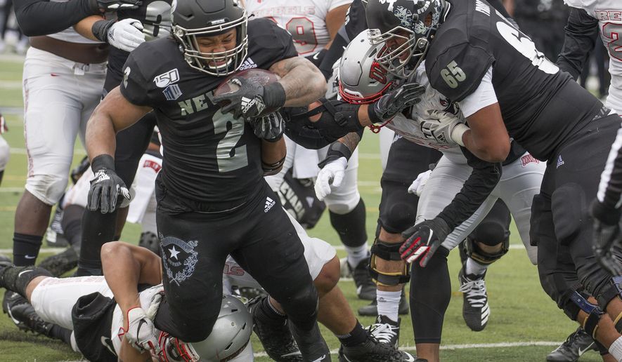Nevada running back Devonte Lee (2) dives into the end zone for a touchdown against UNLV in the first half of an NCAA college football game in Reno, Nev., Saturday, Nov. 30, 2019. (AP Photo/Tom R. Smedes)