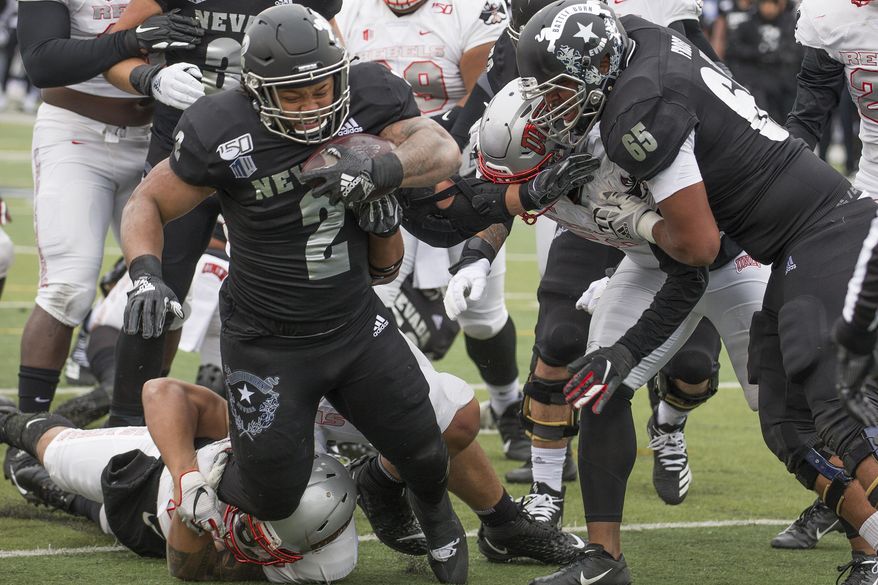 Nevada running back Devonte Lee (2) dives into the end zone for a touchdown against UNLV in the first half of an NCAA college football game in Reno, Nev., Saturday, Nov. 30, 2019. (AP Photo/Tom R. Smedes)