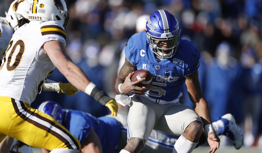 Air Force quarterback Donald Hammond III, right, runs for a short gain as Wyoming linebacker Logan Wilson comes in to make the tackle in the second half of an NCAA college football game Saturday, Nov. 30, 2019, at Air Force Academy, Colo. Air Force won 20-6. (AP Photo/David Zalubowski)