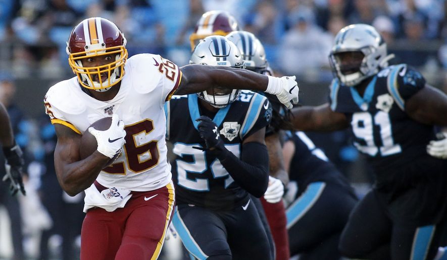 Washington Redskins running back Adrian Peterson (26) runs against the Carolina Panthers during the second half of an NFL football game in Charlotte, N.C., Sunday, Dec. 1, 2019. (AP Photo/Brian Blanco) ** FILE **