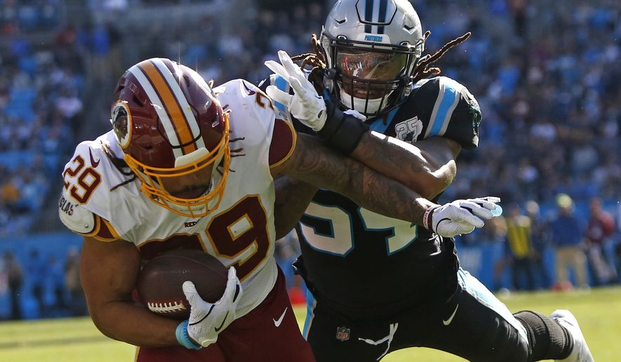 Carolina Panthers outside linebacker Shaq Thompson tackles Washington Redskins running back Derrius Guice (29) during the first half of an NFL football game in Charlotte, N.C., Sunday, Dec. 1, 2019. (AP Photo/Brian Blanco)