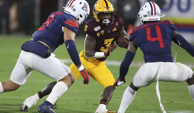 Arizona State's Eno Benjamin (3) is defended by Arizona's Anthony Pandy (8) and Christian Roland-Wallace (4) during the first half of an NCAA college football game, Saturday, Nov. 30, 2019, in Tempe, Ariz. (AP Photo/Darryl Webb)