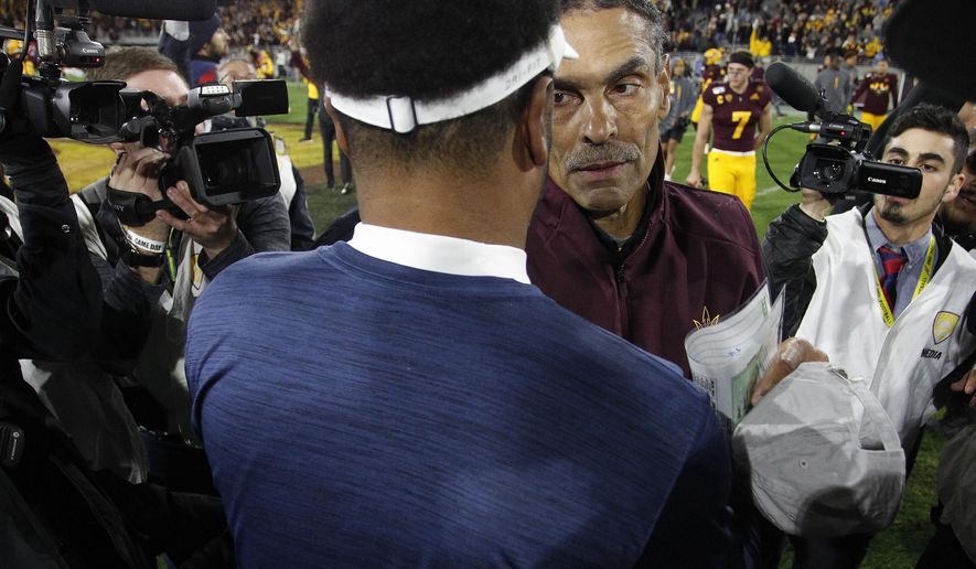 Arizona State head coach Herm Edwards meets Arizona coach Kevin Sumlin at the center of the field after his team defeated Arizona 24-14 in an NCAA college football game, Saturday, Nov. 30, 2019, in Tempe, Ariz. (AP Photo/Darryl Webb)