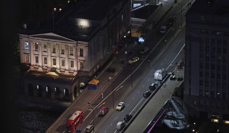 The scene on London Bridge in central London, Saturday, Nov. 30, 2019, after an attack on London Bridge on Friday. UK counterterrorism police on Saturday searched for clues into how a man imprisoned for terrorism offenses before his release last year managed to stab several people before being tackled by bystanders and shot dead by officers on London Bridge. Two people were killed and three wounded. (Yui Mok/PA via AP)