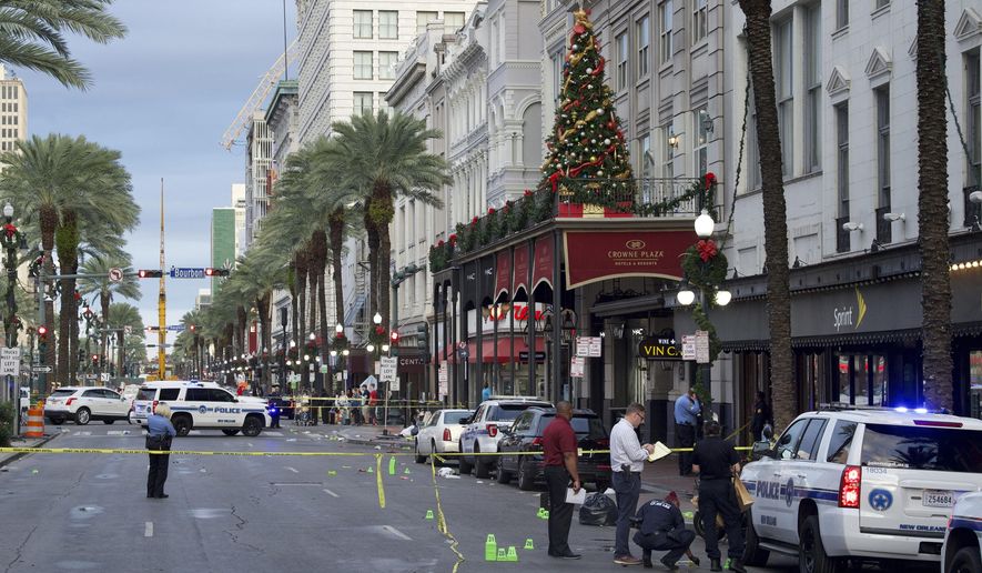 New Orleans police investigate the scene of a shooting Sunday, Dec. 1, 2019, on the edge of the city's famed French Quarter in New Orleans. (Max Becherer/The Advocate via AP)