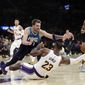 Los Angeles Lakers&#39; LeBron James (23) recovers a loose ball under Dallas Mavericks&#39; Luka Doncic (77) during the first half of an NBA basketball game Sunday, Dec. 1, 2019, in Los Angeles. (AP Photo/Marcio Jose Sanchez)