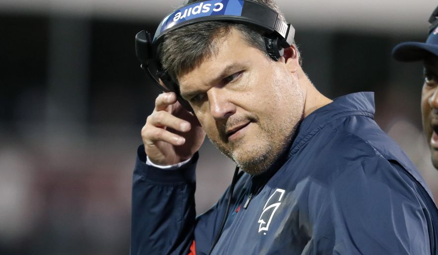 In this Nov. 28, 2019 photo, Mississippi head coach Matt Luke removes his headset during an NCAA college football game against Mississippi State, in Starkville, Miss. Mississippi has fired Luke, three days after his third non-winning season ended with an excruciating rivalry game loss. Athletic director Keith Carter said Sunday, Dec. 1, 2019 the decision to change coaches was made after evaluating the trajectory of the program and not seeing enough “momentum on the field.” (AP Photo/Rogelio V. Solis)