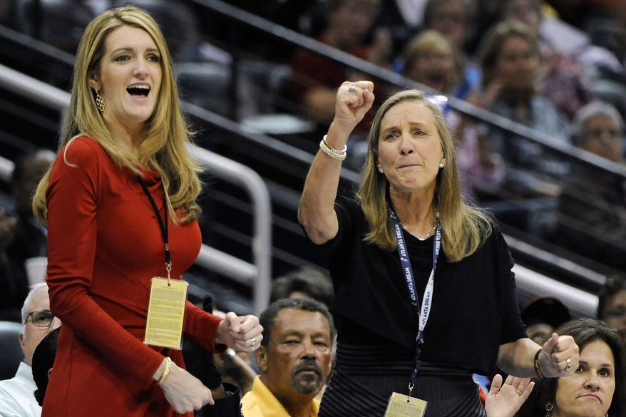 -In this Tuesday, Sept. 6, 2011 file photo, Mary Brock, right, and Kelly Loeffler cheer from their courtside seats as the Atlanta Dream basketball team plays in the second half of their WNBA basketball game, in Atlanta. Republican donor and financial services executive Loeffler tapped by Georgia governor Kemp for U.S. Senate seat as three-term Republican Sen. Johnny Isakson, who is stepping down because of health issues. (AP Photo/David Tulis, ) **FILE**