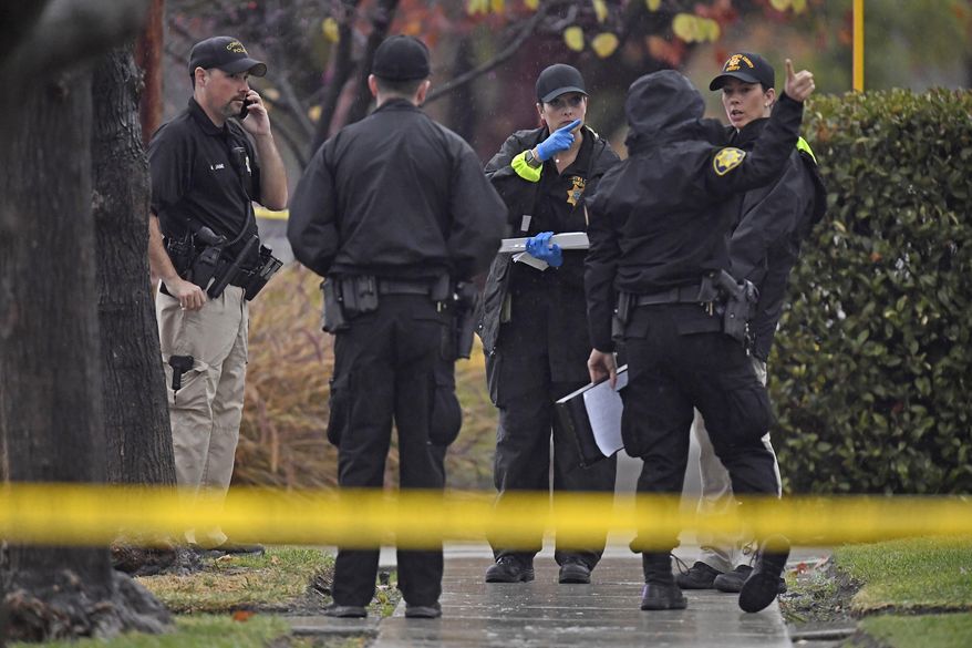In this photo taken Sunday, Dec. 1, 2019, police officers investigate the scene of an officer-involved shooting in Concord, Calif. Police in Northern California say Concord police officers shot and killed a 60-year-old man after he allegedly attacked his elderly parents. KPIX-TV reports the shooting Sunday in Concord happened after an older couple, aged 85 and 90, called police and said their son was acting "erratically" and was possible under the influence of drugs and alcohol. (Jose Carlos Fajardo/Bay Area News Group via AP)