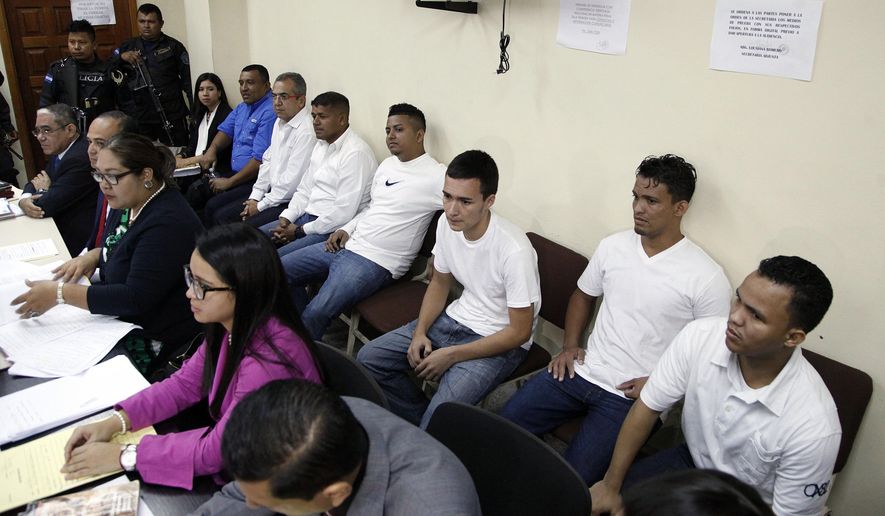 FILE - In this Oct. 15, 2018 file photo, men accused in the murder of Honduran indigenous and environmental rights activist Berta Caceres sit in the courtroom in Tegucigalpa, Honduras. A Honduran court has sentenced seven people convicted of participating in the 2016 murder of Caceres to prison terms of up to 50 years. The court announced the sentences Monday, Dec. 2, 2019. (AP Photo/Fernando Antonio, File)