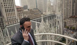 In this Tuesday, Oct. 29, 2019, photo, attorney Adam Slater takes a phone call on a patio outside his high-rise Manhattan office overlooking St. Patrick&#39;s Cathedral, in New York. Slater&#39;s firm is representing clients accusing the Roman Catholic Church of sexual abuse, a clientele that is rapidly growing after New York state opened its one-year window allowing sex abuse suits with no statute of limitations. (AP Photo/Bebeto Matthews) ** FILE **