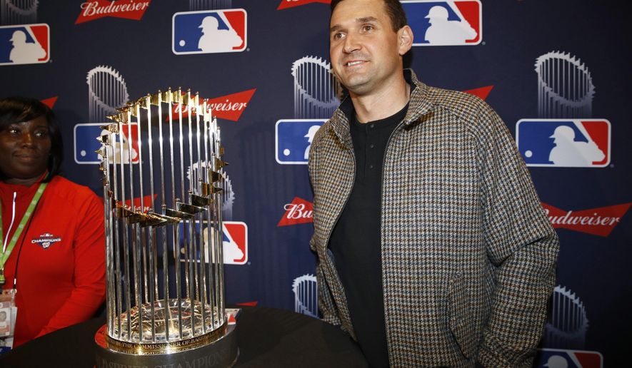 Washington Nationals first baseman Ryan Zimmerman poses with the World Series trophy as he arrives for the premiere of a documentary film on the team&#x27;s first World Series baseball championship, Monday, Dec. 2, 2019, in Washington. (AP Photo/Patrick Semansky)