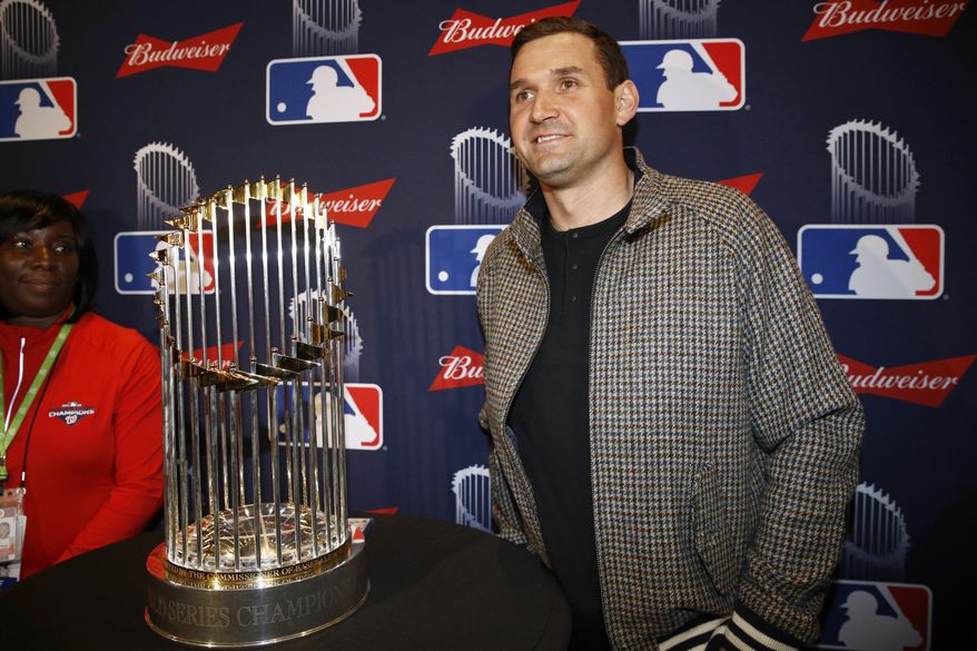 Washington Nationals first baseman Ryan Zimmerman poses with the World Series trophy as he arrives for the premiere of a documentary film on the team's first World Series baseball championship, Monday, Dec. 2, 2019, in Washington. (AP Photo/Patrick Semansky)