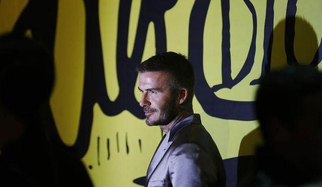 David Beckham poses for a photograph before a Christian Dior pre-fall 2020 men&#x27;s fashion collection presentation during Art Basel on Tuesday, Dec. 3, 2019, in Miami. (AP Photo/Brynn Anderson)