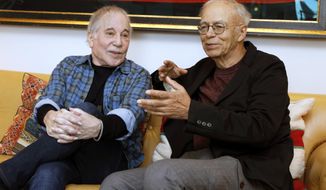 This Nov. 8, 2019 photo shows singer-songwriter, Paul Simon, left, and author-philosopher Peter Singer during an interview in New York to promote the new edition of Singer&#39;s book “The Life You Can Save.&amp;quot; (AP Photo/Richard Drew)