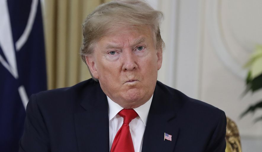 U.S. President Donald Trump grimaces during a meeting with NATO Secretary General, Jens Stoltenberg at Winfield House in London, Tuesday, Dec. 3, 2019. US President Donald Trump will join other NATO heads of state at Buckingham Palace in London on Tuesday to mark the NATO Alliance's 70th birthday. (AP Photo/Evan Vucci)
