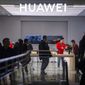 In this Nov. 20, 2019, photo, customers shop at a Huawei store at a shopping mall in Beijing. The founder of Huawei says the Chinese tech giant is moving its U.S. research center to Canada due to American restrictions on its activities. (AP Photo/Mark Schiefelbein)