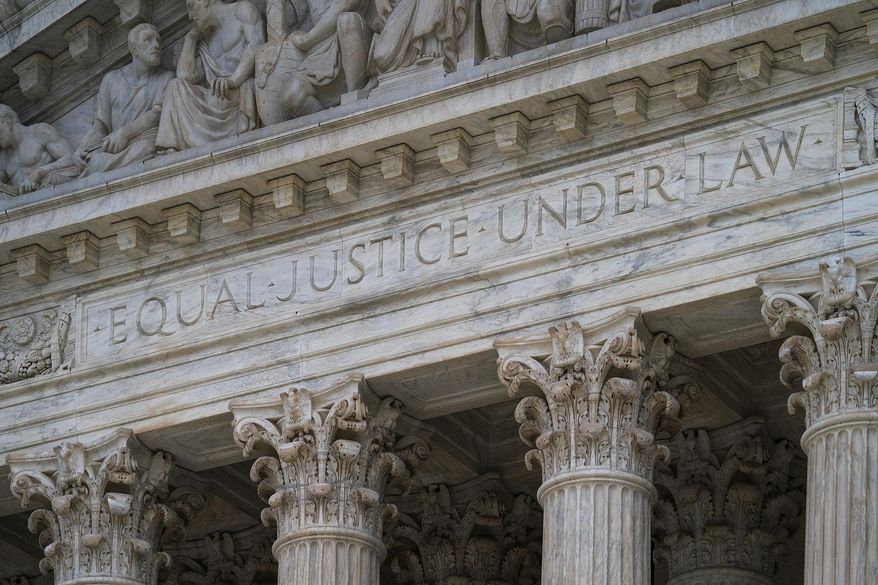 FILE - In this March 20, 2019, file photo, the west facade of the Supreme Court Building bears the motto "Equal Justice Under Law," in Washington. Racial disparities have narrowed across the United States criminal justice system since 2000, though blacks remain significantly more likely to be impacted than whites. A study released Tuesday, Dec. 3, 2019 by the nonpartisan Council on Criminal Justice found racial gaps declined in local jails and state prisons, and among those on probation and parole. (AP Photo/J. Scott Applewhite, File)
