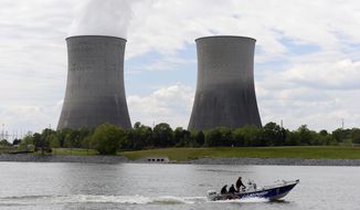 FILE - In this April 29, 2015 file photo, a boat travels on the Tennessee River near the Watts Bar Nuclear Plant near Spring City, Tenn. Federal regulators have fined the nation’s largest public utility $145,000 for submitting incomplete and inaccurate information on a backup system at its Watts Bar Nuclear Plant. The Nuclear Regulatory Commission notified the Tennessee Valley Authority of the proposed fine regarding the Spring City, Tennessee plant in a Nov. 19, 2019 letter. The utility says it has taken corrective action, adding that the backup configuration was never used.  (AP Photo/Mark Zaleski, File)
